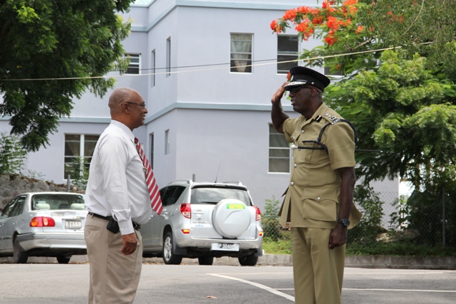 Newly sworn-in Commissioner of Police for the Royal St. Christopher and Nevis Police Force, Mr. Celwyn Walwyn, salutes Premier of Nevis the Honourable Joseph Parry.